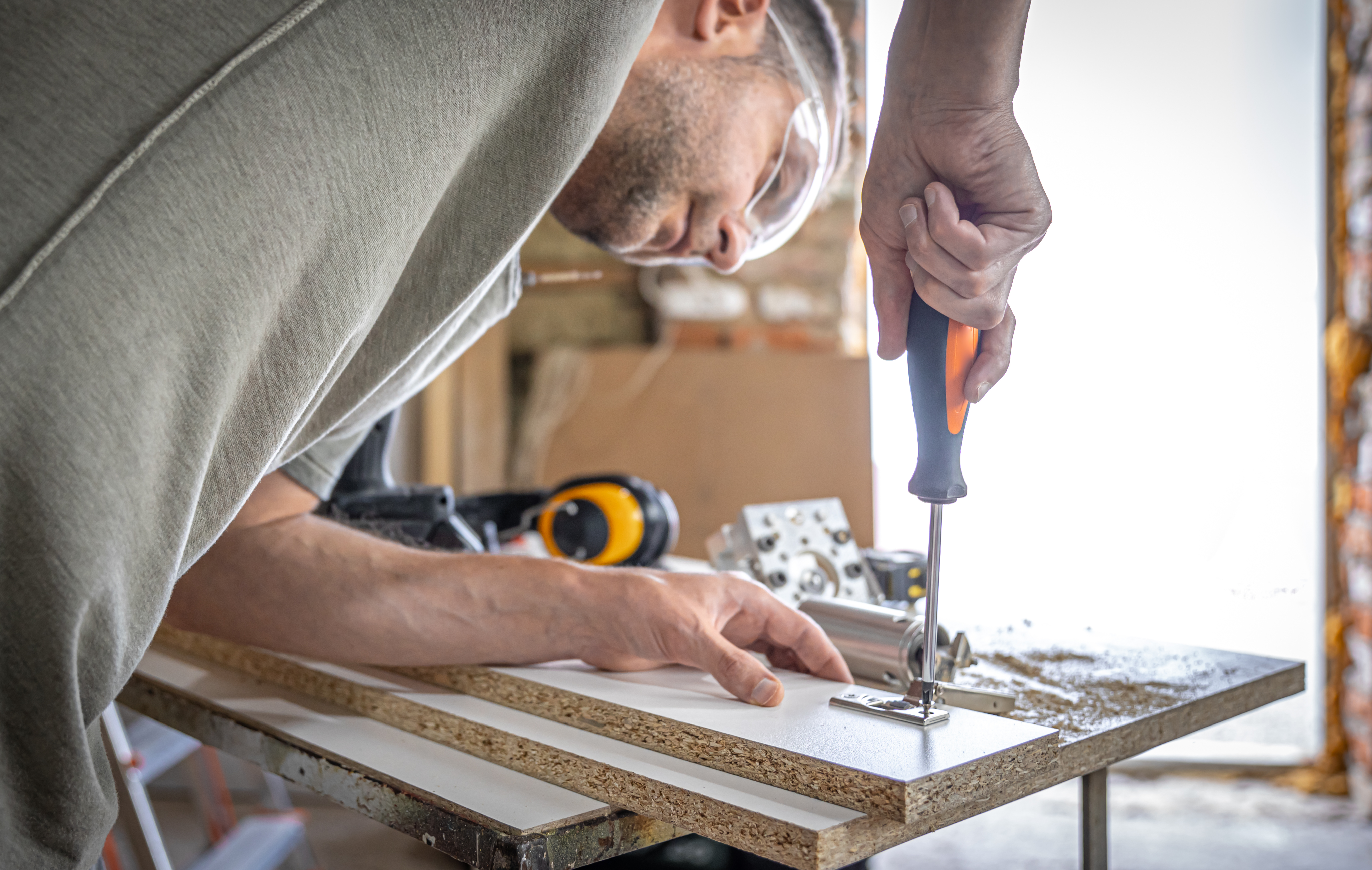 screwing-self-tapping-screw-into-metal-fastening-hole-wood-strip-using-screwdriver-work-carpenter.jpg