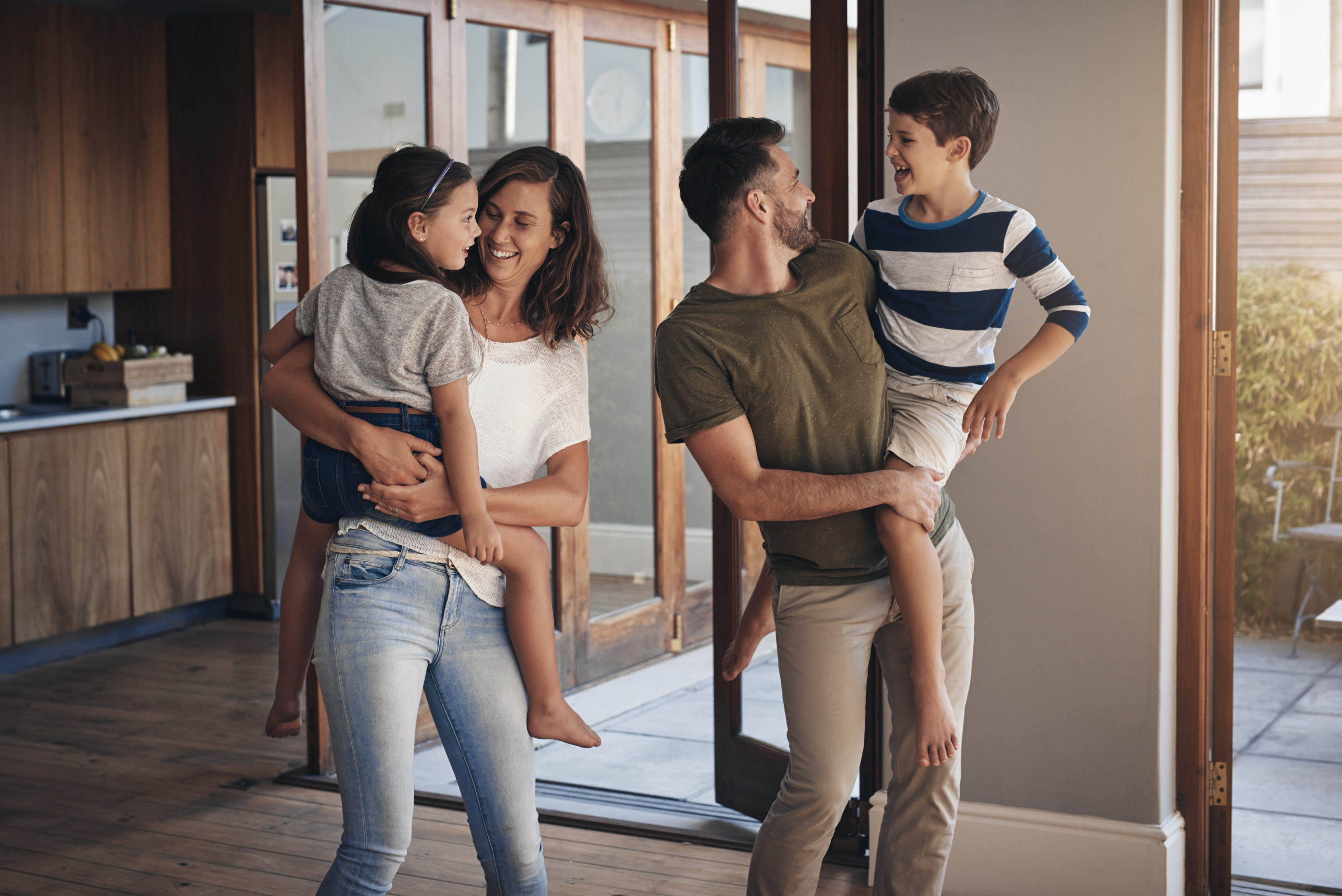 family-home-children-parents-bonding-together-fun-support-living-room-lounge-house-woman-man-kids-with-hug-playful-happiness-weekend-summer-vacation-break.jpg