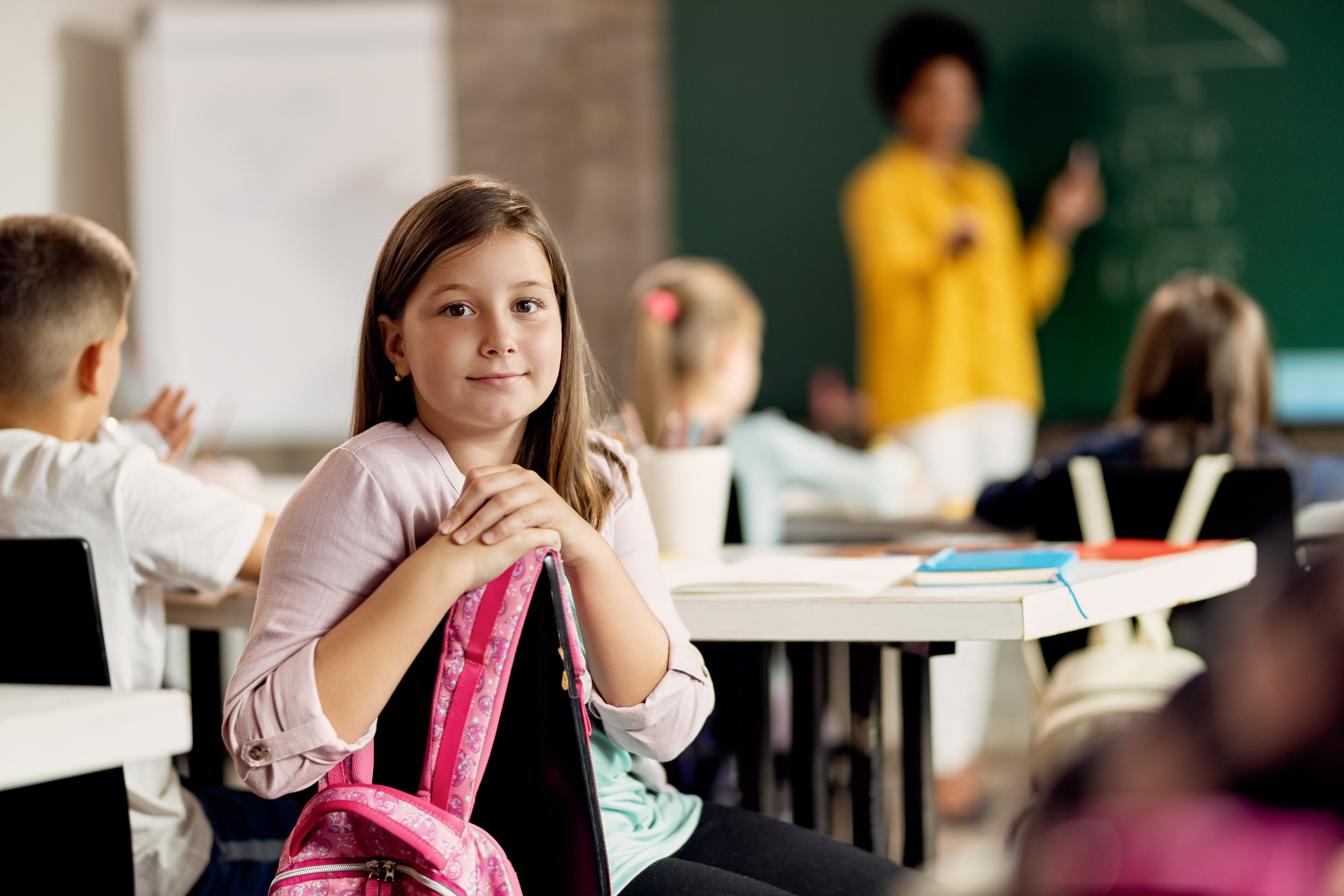 cute-schoolgirl-looking-camera-class-classroom.jpg